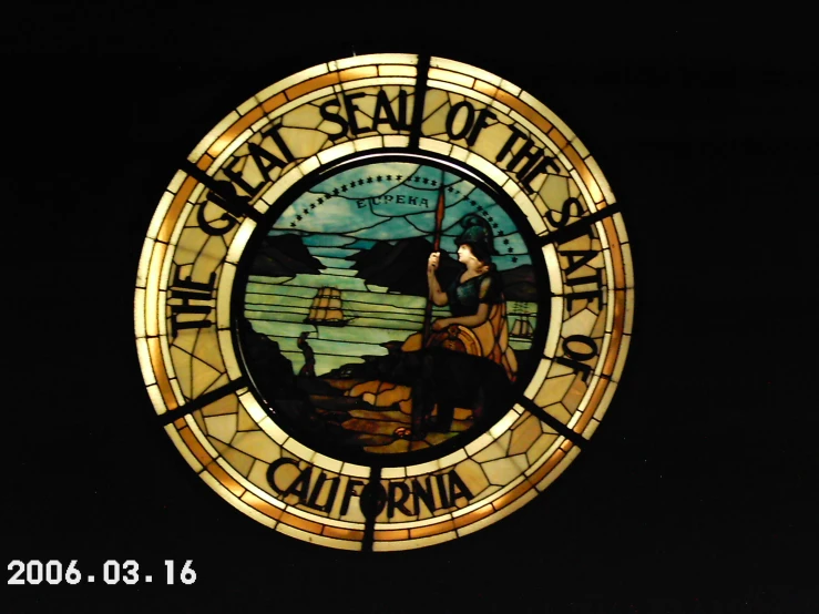 a stained glass window showing the seal of the state of california