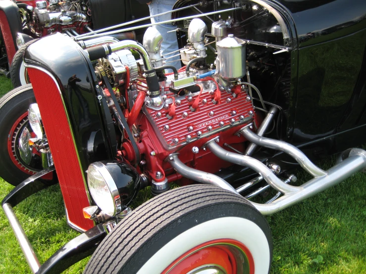 an older looking car engine with a lot of chrome on the hood