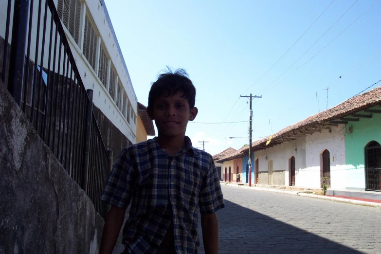 a young man standing outside on a street