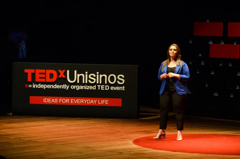 a person is standing on the stage in front of a sign