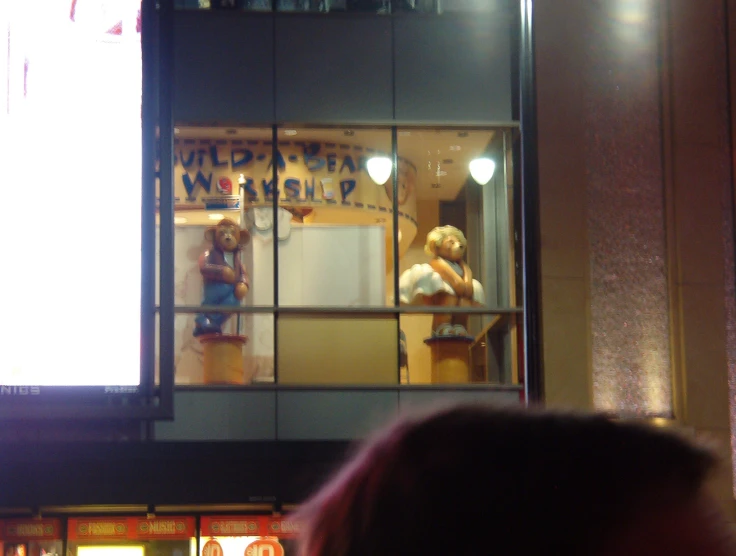 a window display of a couple of wooden doll's