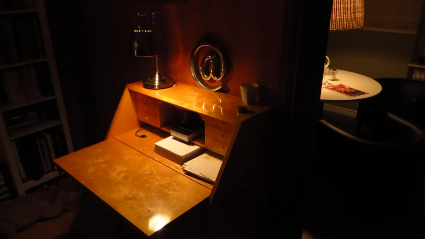 an office desk area with a small lamp beside it