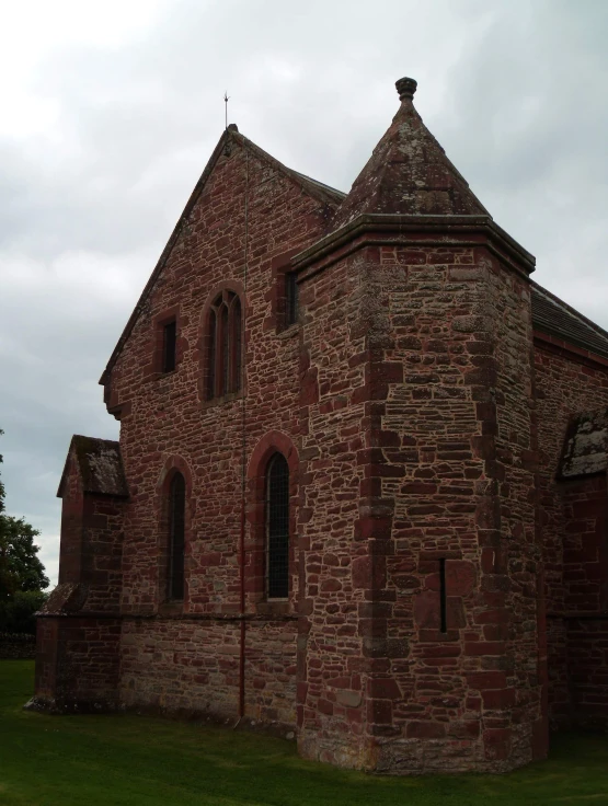 the front side of an old brick church