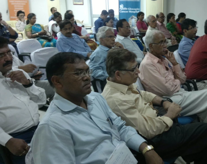 a crowd of people sitting in the room