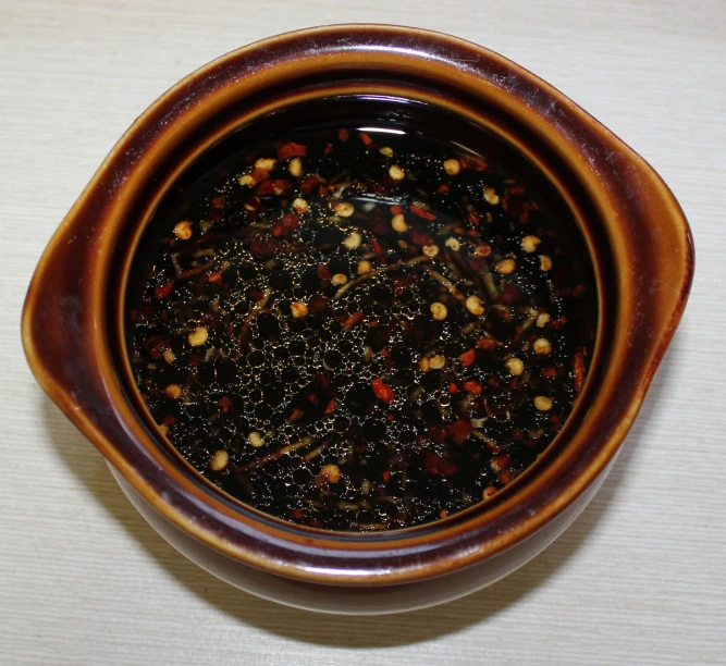 the bowl is full of cooked beans and chilies