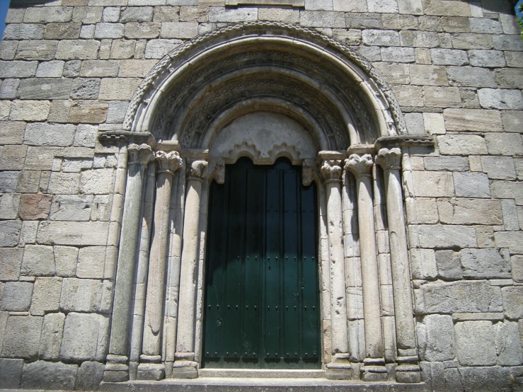 a large stone building with a black doorway