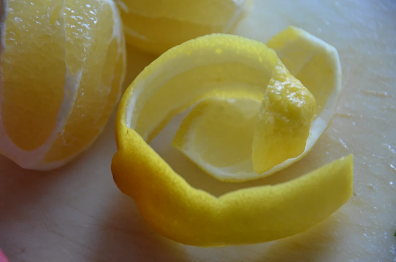 peeled and cut lemons displayed on  board