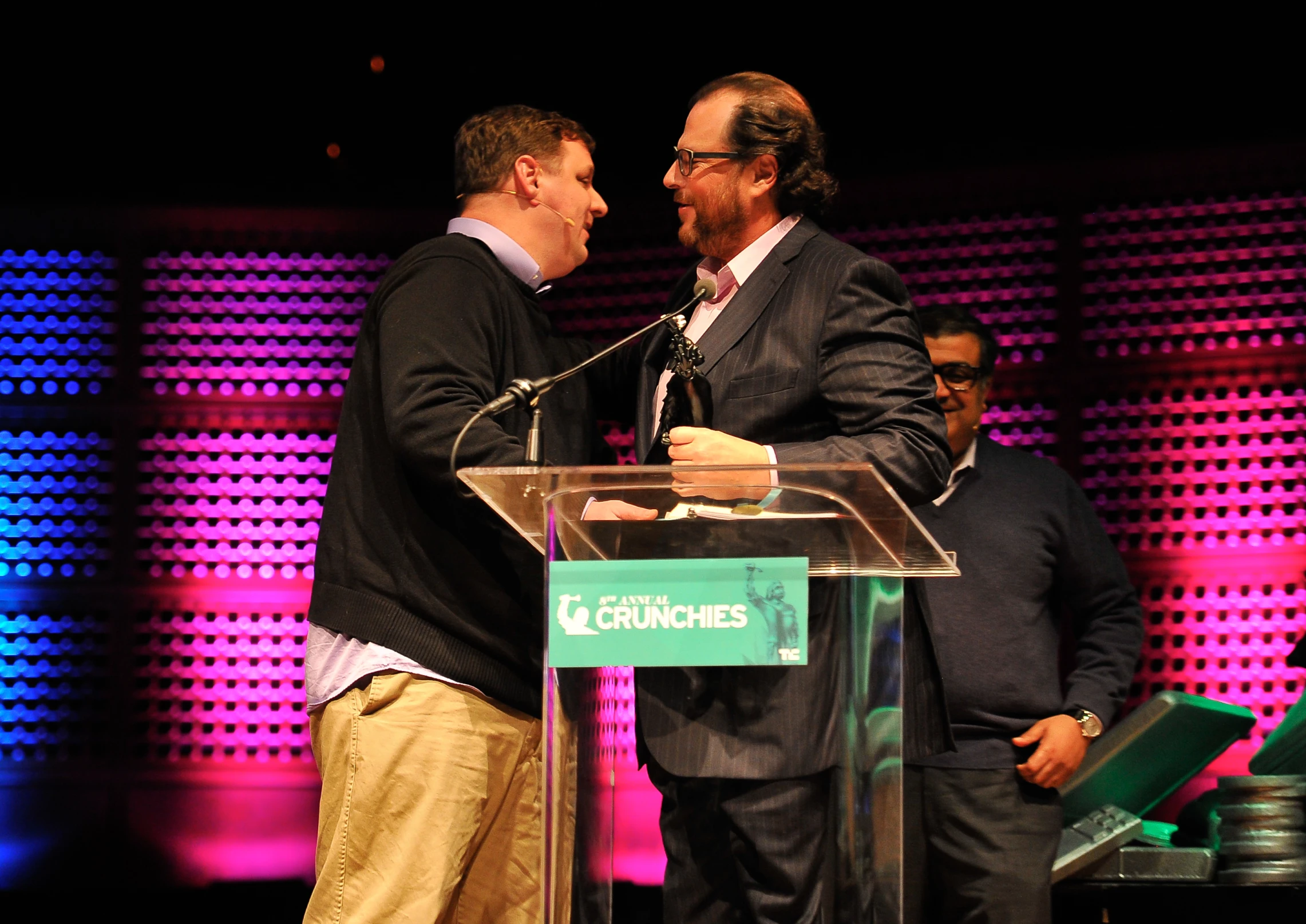 two men are standing in front of a podium