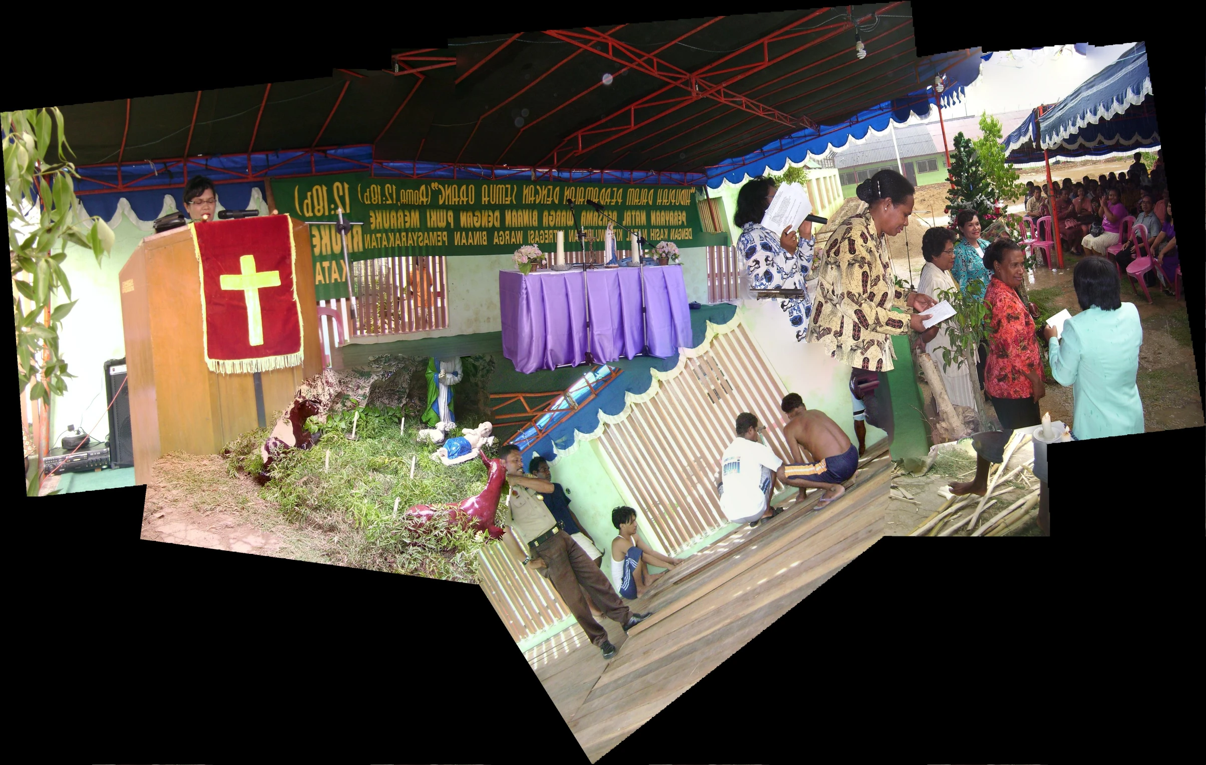 people standing and laying in a field under a tent