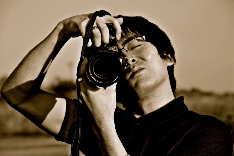 a man holding his camera to take pictures