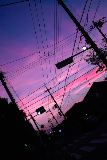 purple and purple colored sky at sunset with power lines