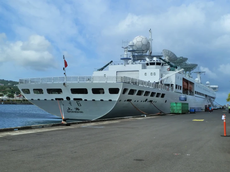 a large boat is in the water on the pavement