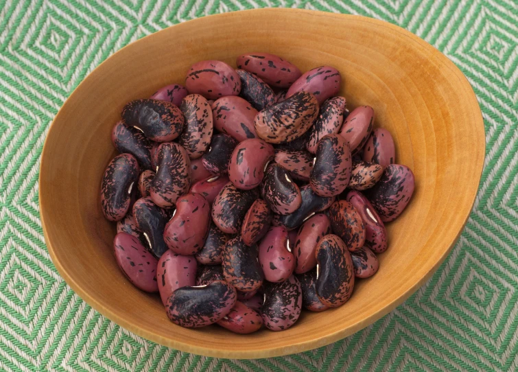 a brown bowl full of red bean seeds