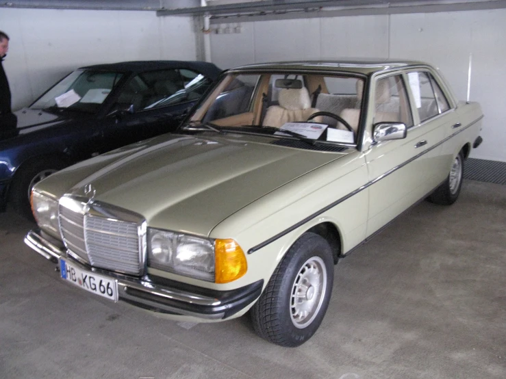 an old mercedes benz parked inside a garage