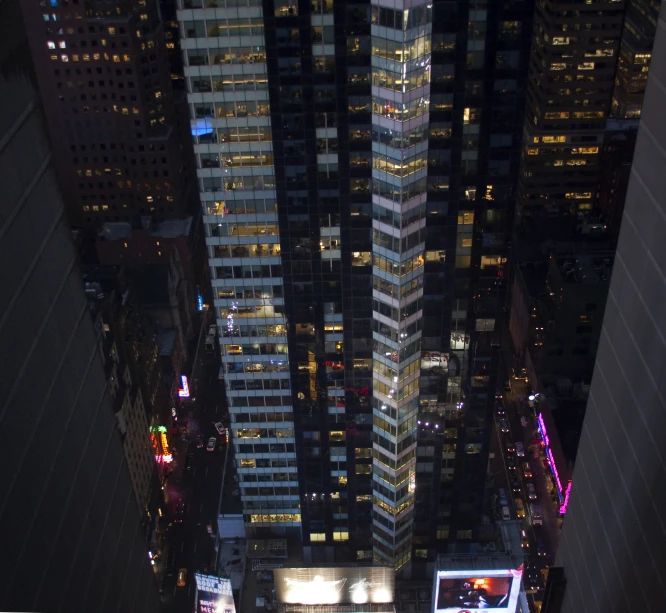 tall buildings with lit up windows in the city