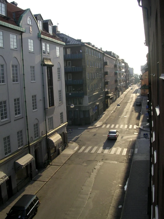 looking down the street at several tall buildings