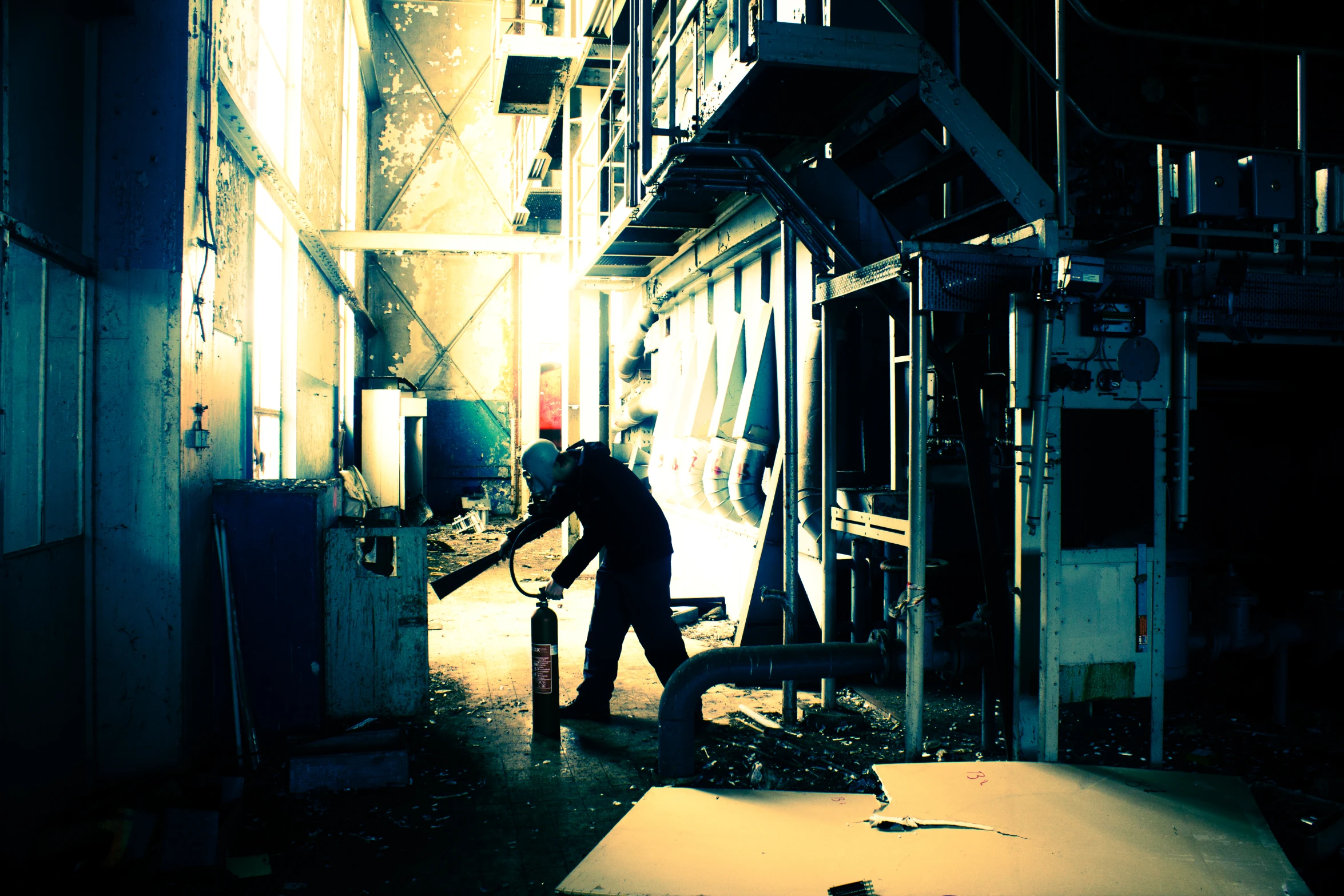 an industrial worker walking inside a factory alone