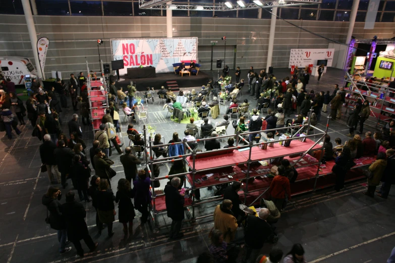 a crowd is gathered around a stage that is set up for a show