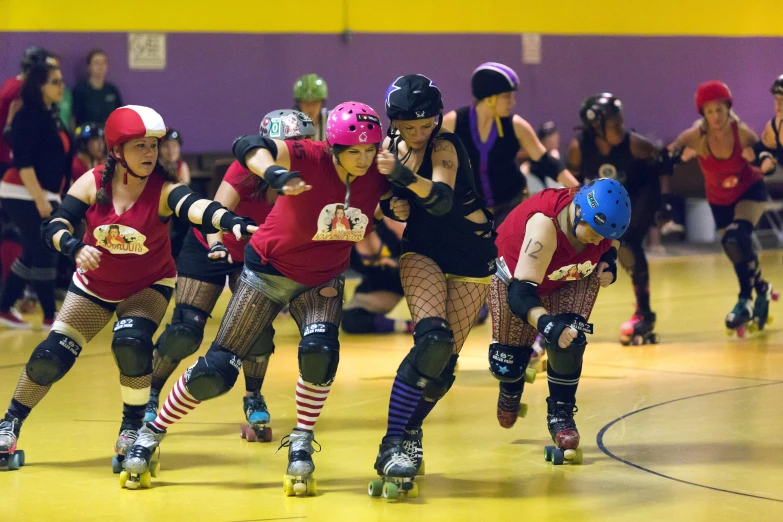 a group of roller blade skaters wearing red uniforms