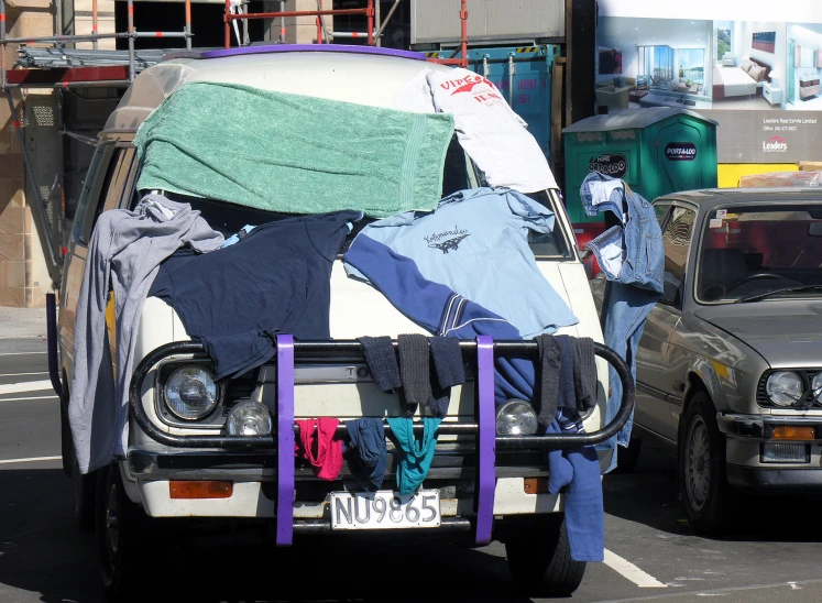 an open car with clothes and shirts in the back