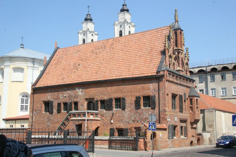 an old brick church with two steeple tops