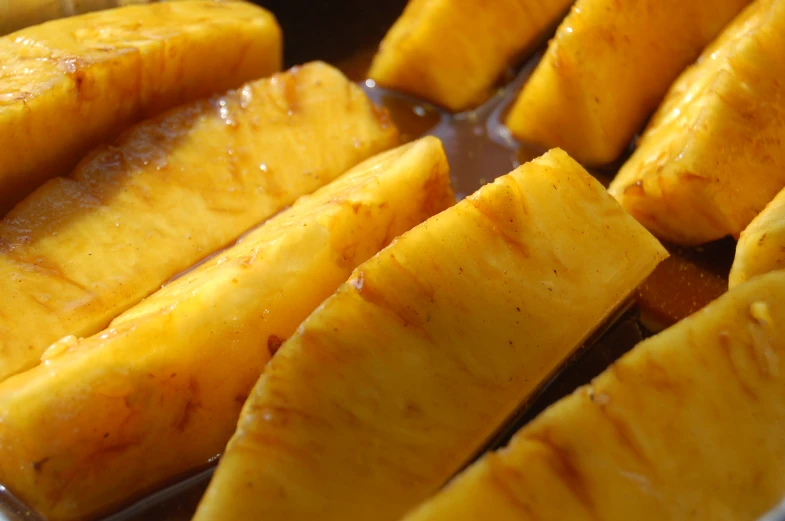 close up of sliced bananas and oil in pan