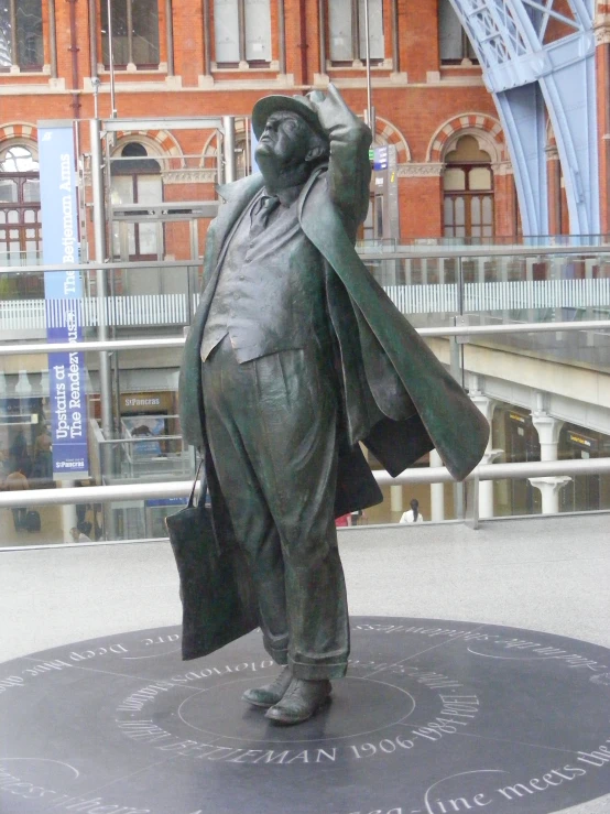 a statue in front of an old building