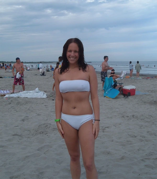 there is a woman wearing a white bikini on a beach