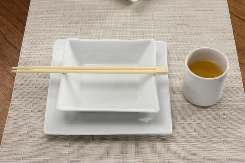 two square plates, with chopsticks next to one