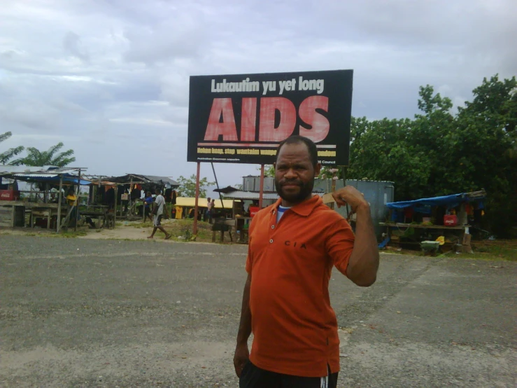 an older man is standing outside with his thumbs up