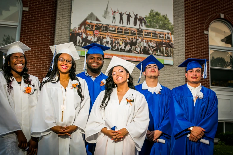 a group of graduating students pose for a po