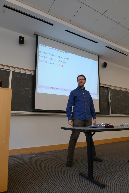 man in front of projector with projection screen