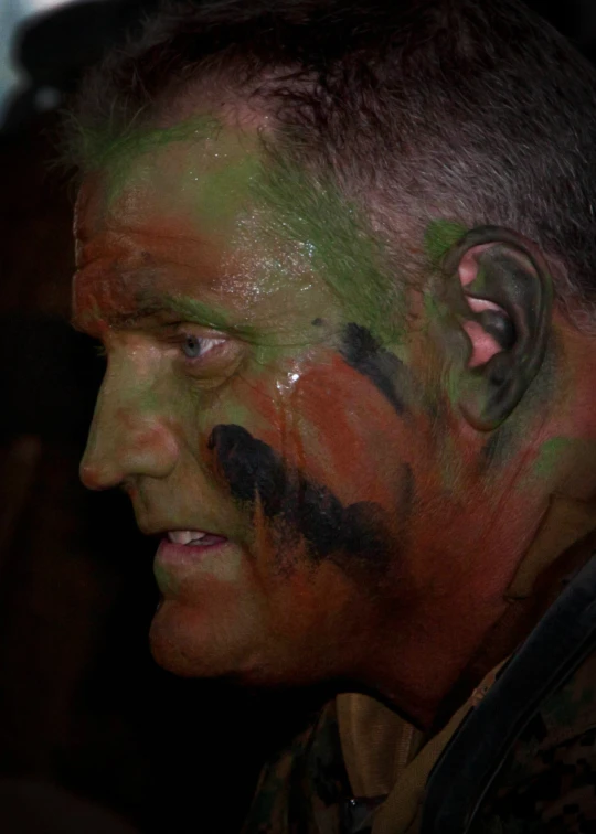 a man with painted face and hair in uniform