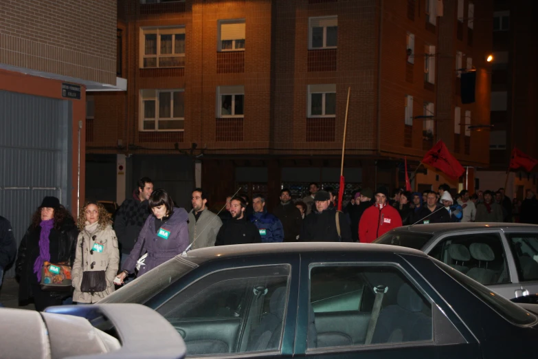 many people standing in the middle of a street