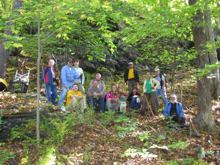 a group of people in the forest posing for a picture