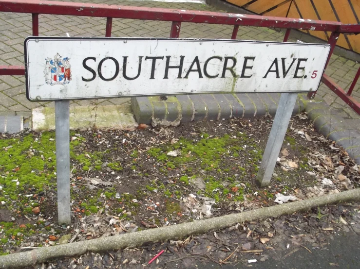 a sign in front of a metal fence that says southacre ave