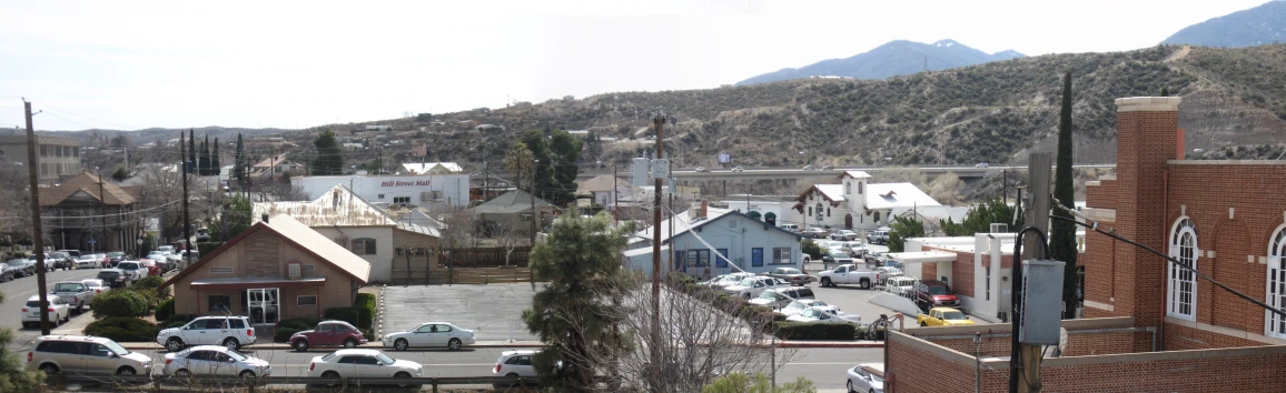 there are cars driving down the road in this small town