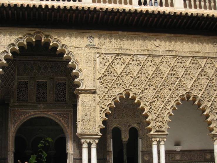 a building with arches and people standing on the outside of it