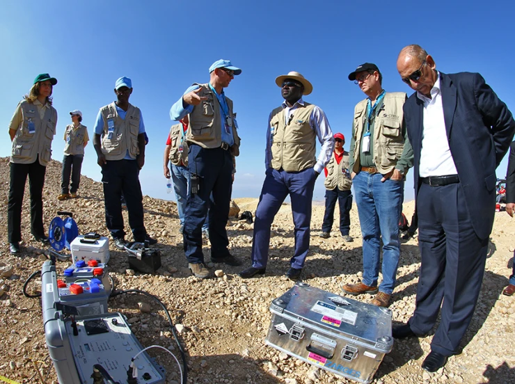 a group of people that are standing in the dirt