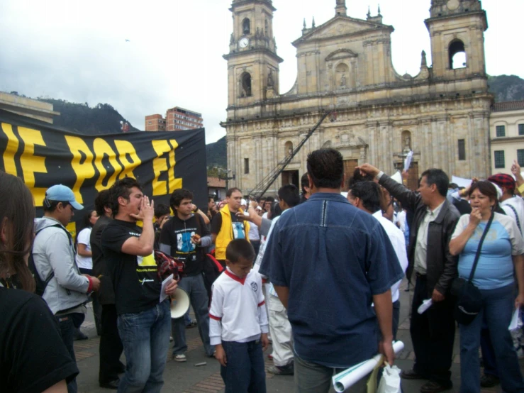 a group of people gathered in a street with buildings