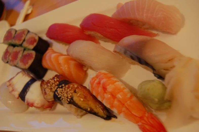 a plate of sushi is on display with chopsticks