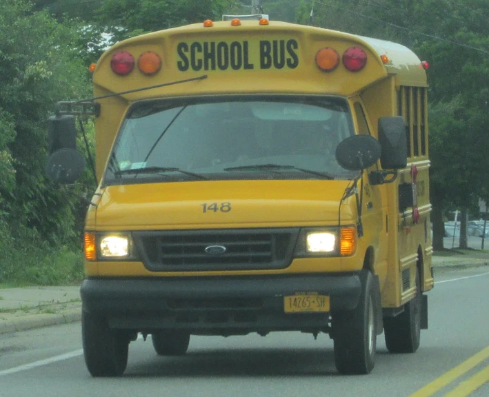 a school bus driving down a street in a city
