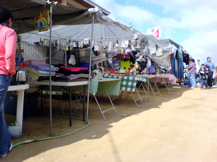 a woman is looking through some kind of tent