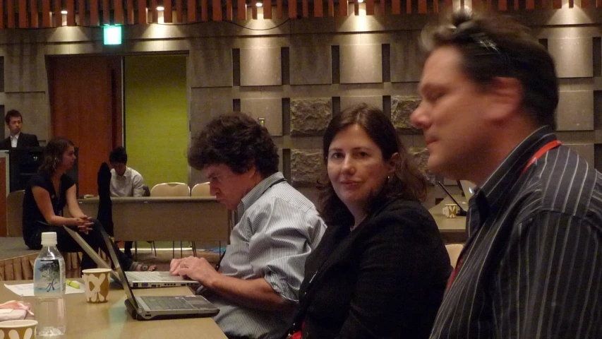 three people are using their laptops on the table