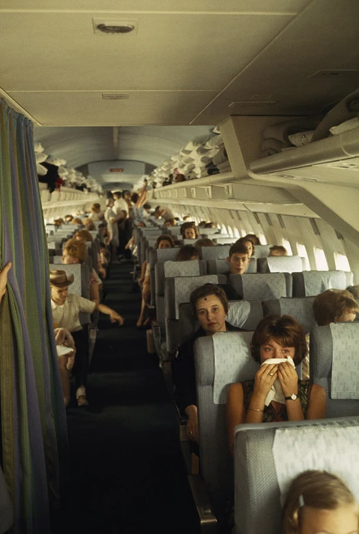 a group of people sitting inside of an airplane