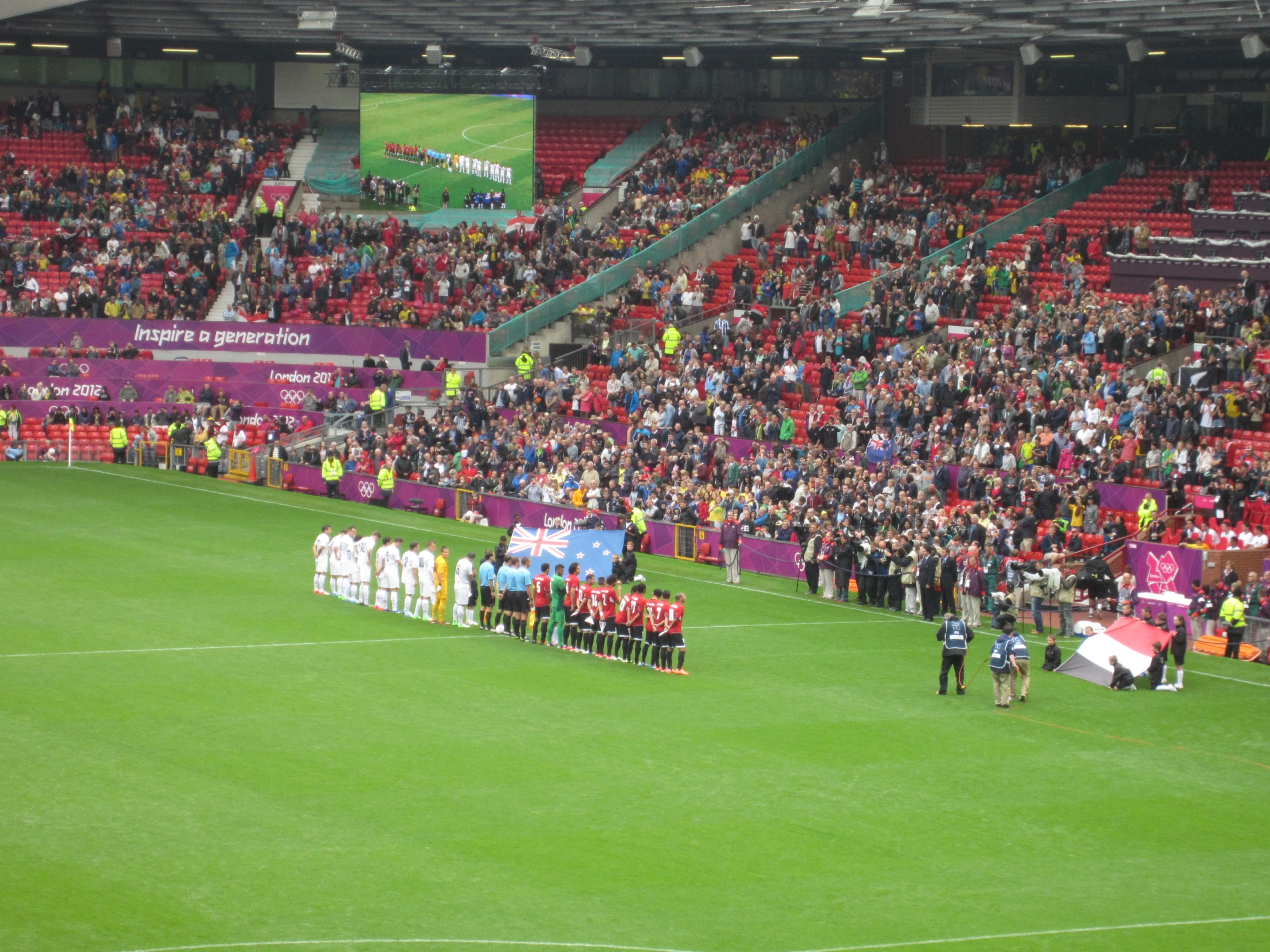 an empty soccer field with players and a banner