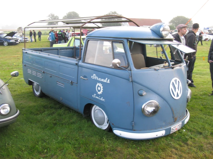 an old vw bus with surfboards on top of it