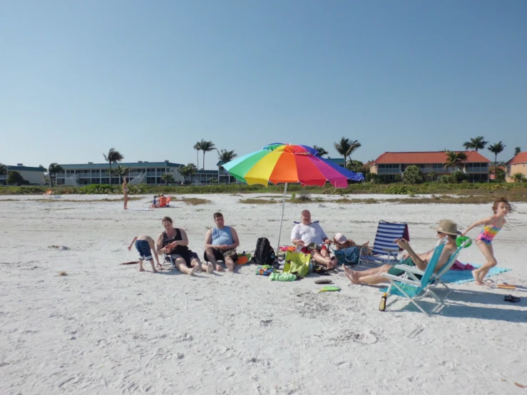 people sit on the beach and play in the sand