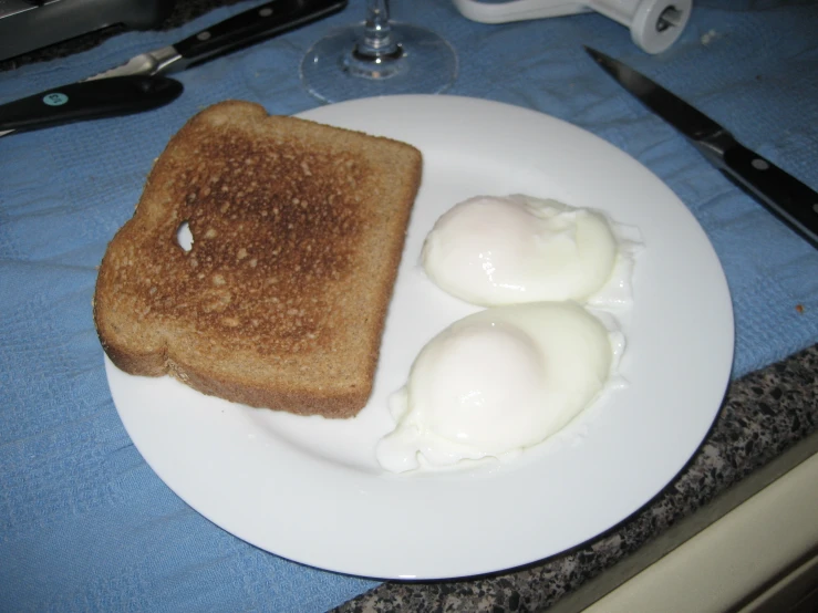 two eggs are sitting on top of toast on a plate