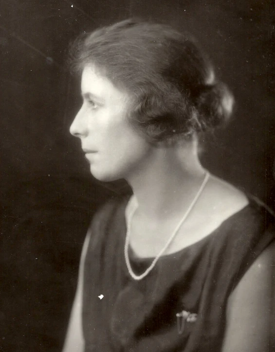 an old fashioned portrait of a woman with a necklace